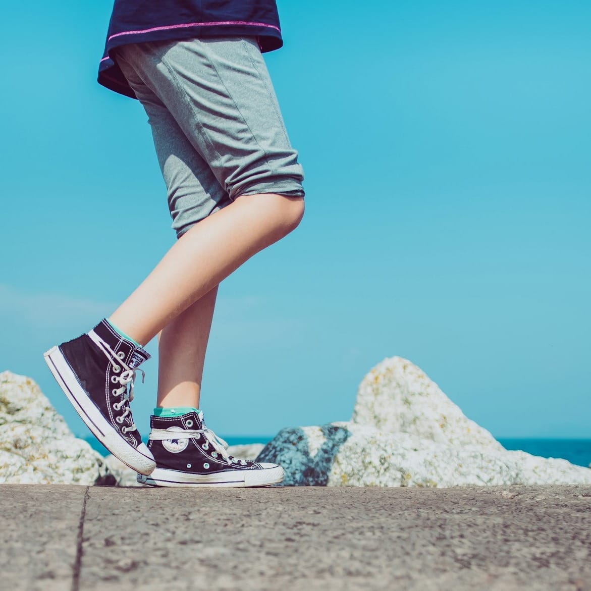 person walking on gray concrete pavement