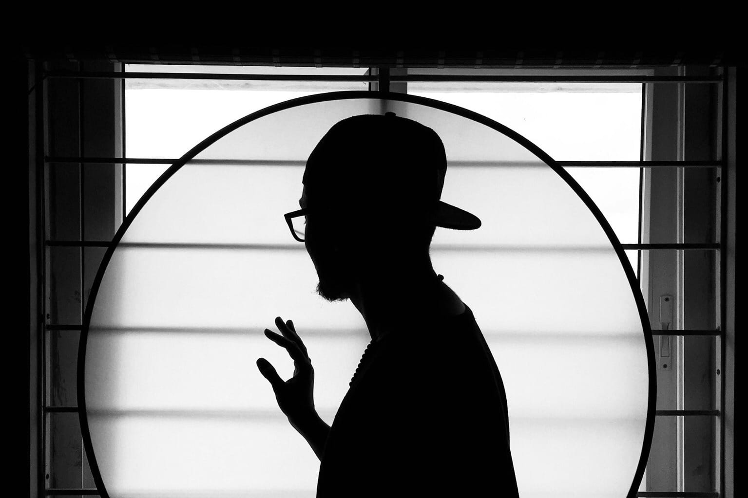 silhouette of man standing on window